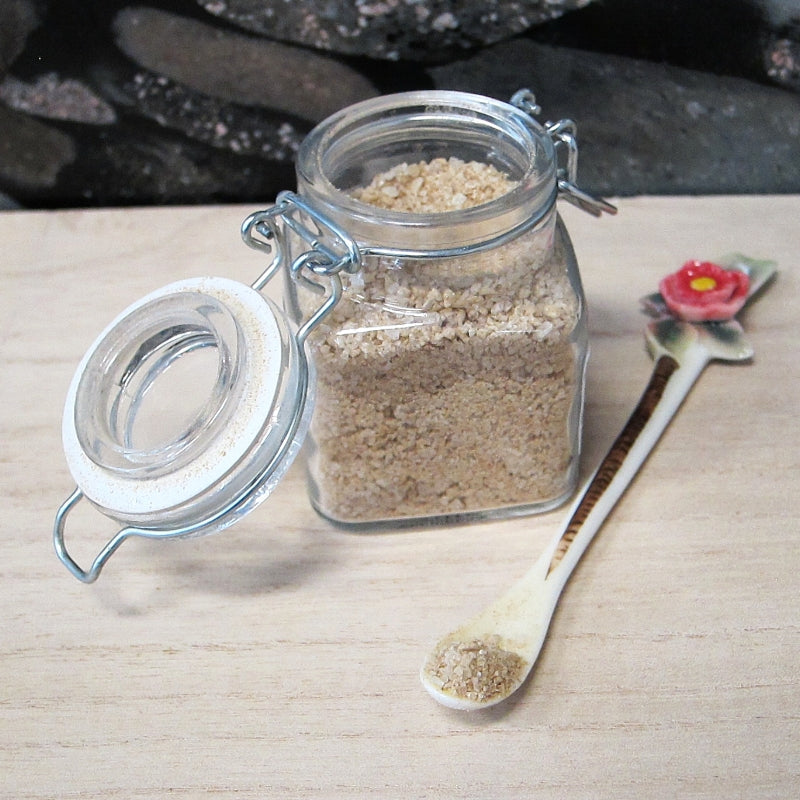 sea salt and ginger in a jar with a salt spoon